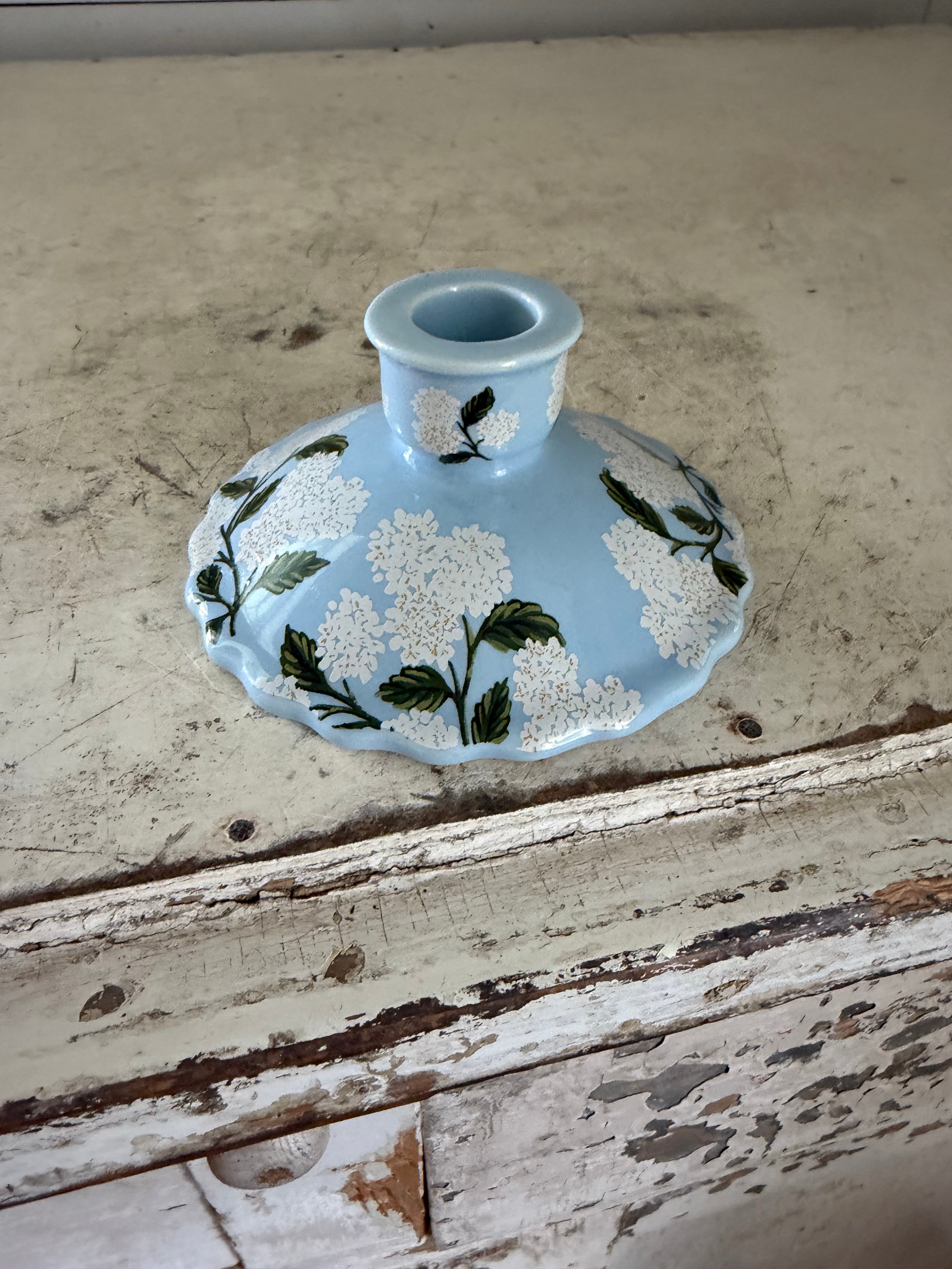 Blue candlestick with white flowers