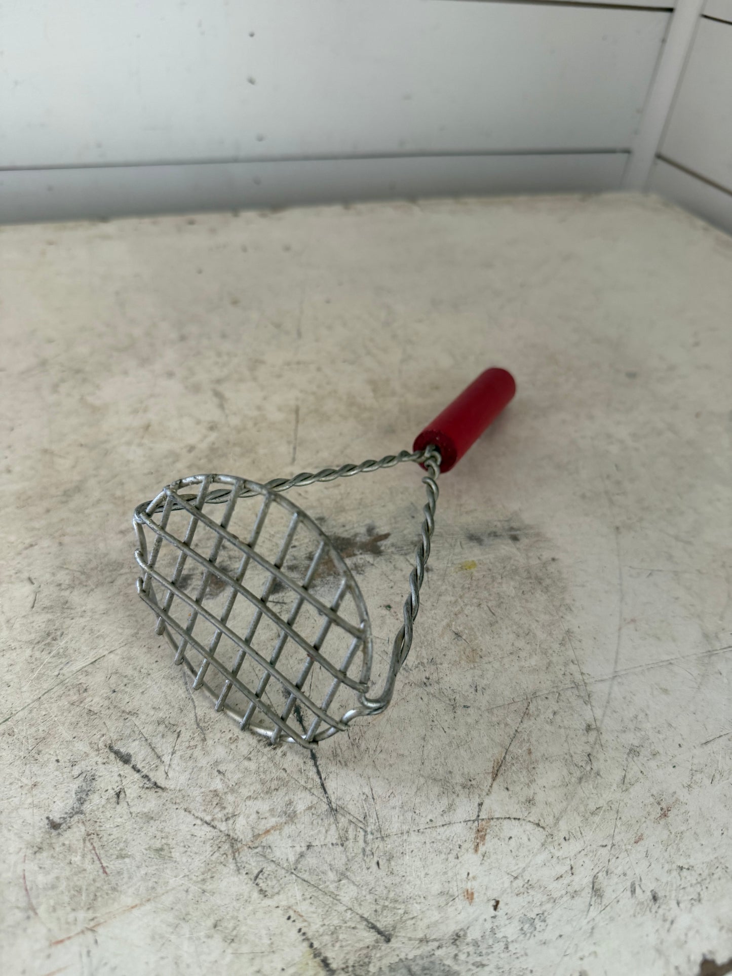 Vintage potato masher with twisted wire and wood handle