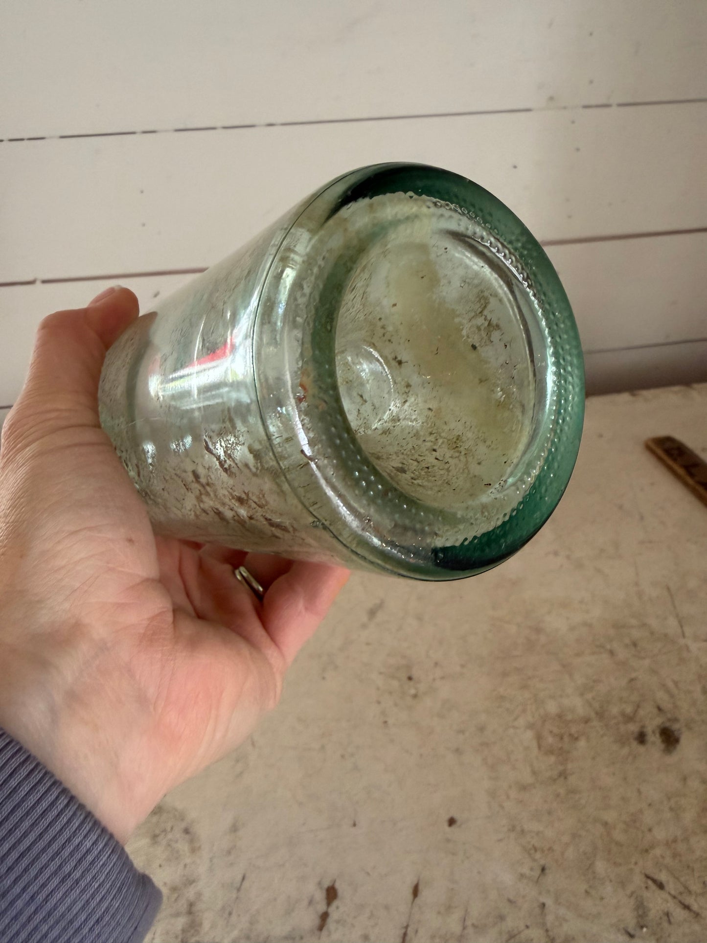 Early 20th Century Hand Blown Light Green Glass Bottle with dimpled bottom