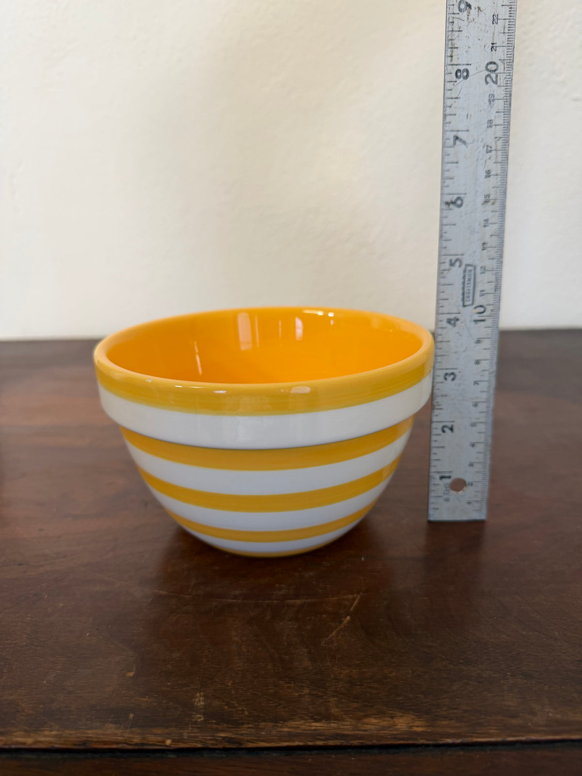 Yellow and white ceramic striped bowl