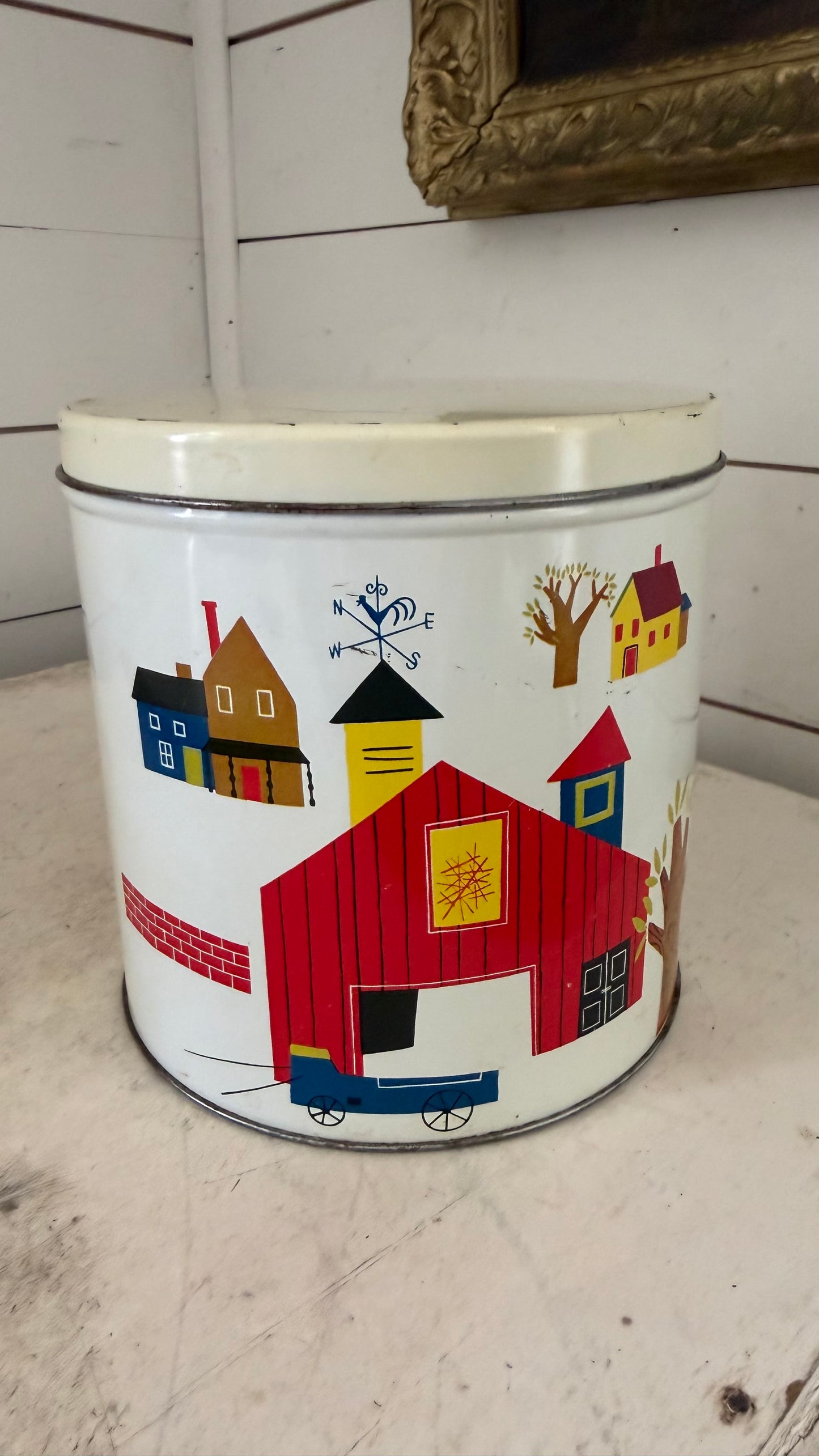 Vintage tin canister with red barn on it