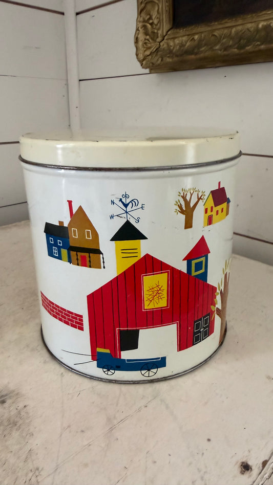 Vintage tin canister with red barn on it