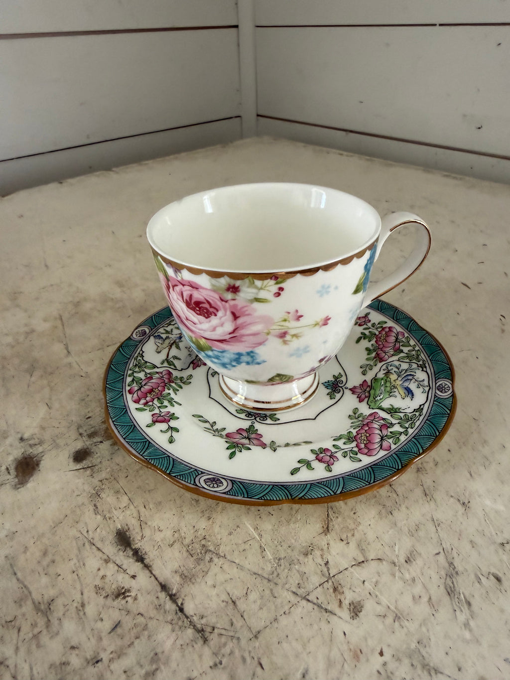 Mismatched, teacup, and saucer as is small chip