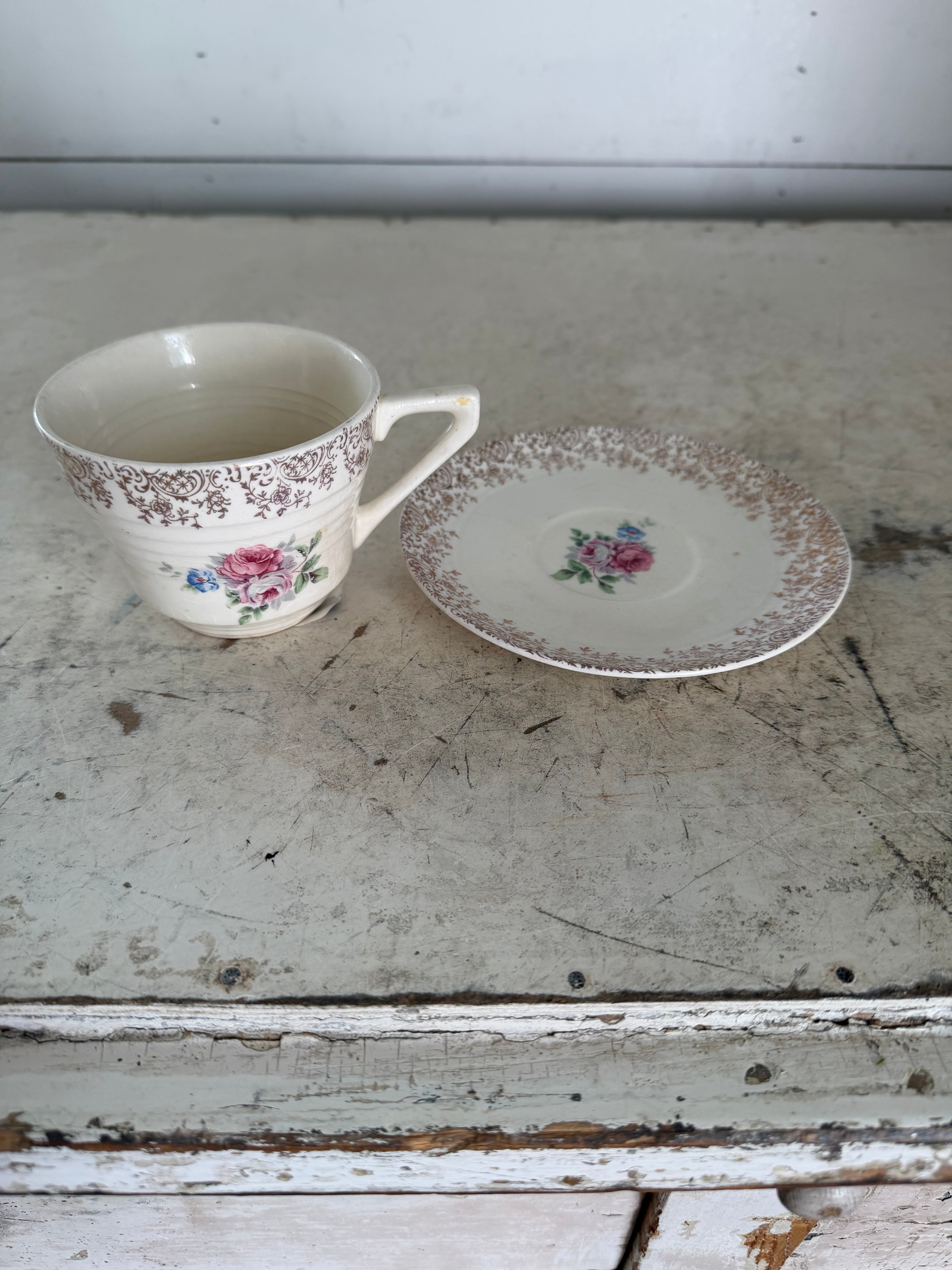 Vintage porcelain teacup and saucer with gold filigree