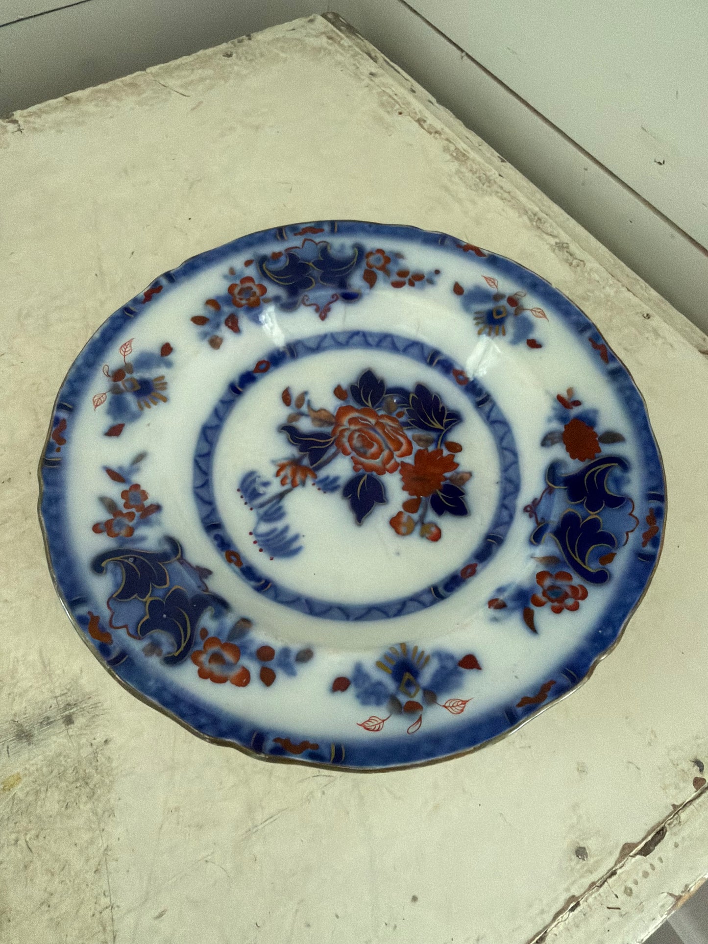 Flow blue plate made in England has small crack