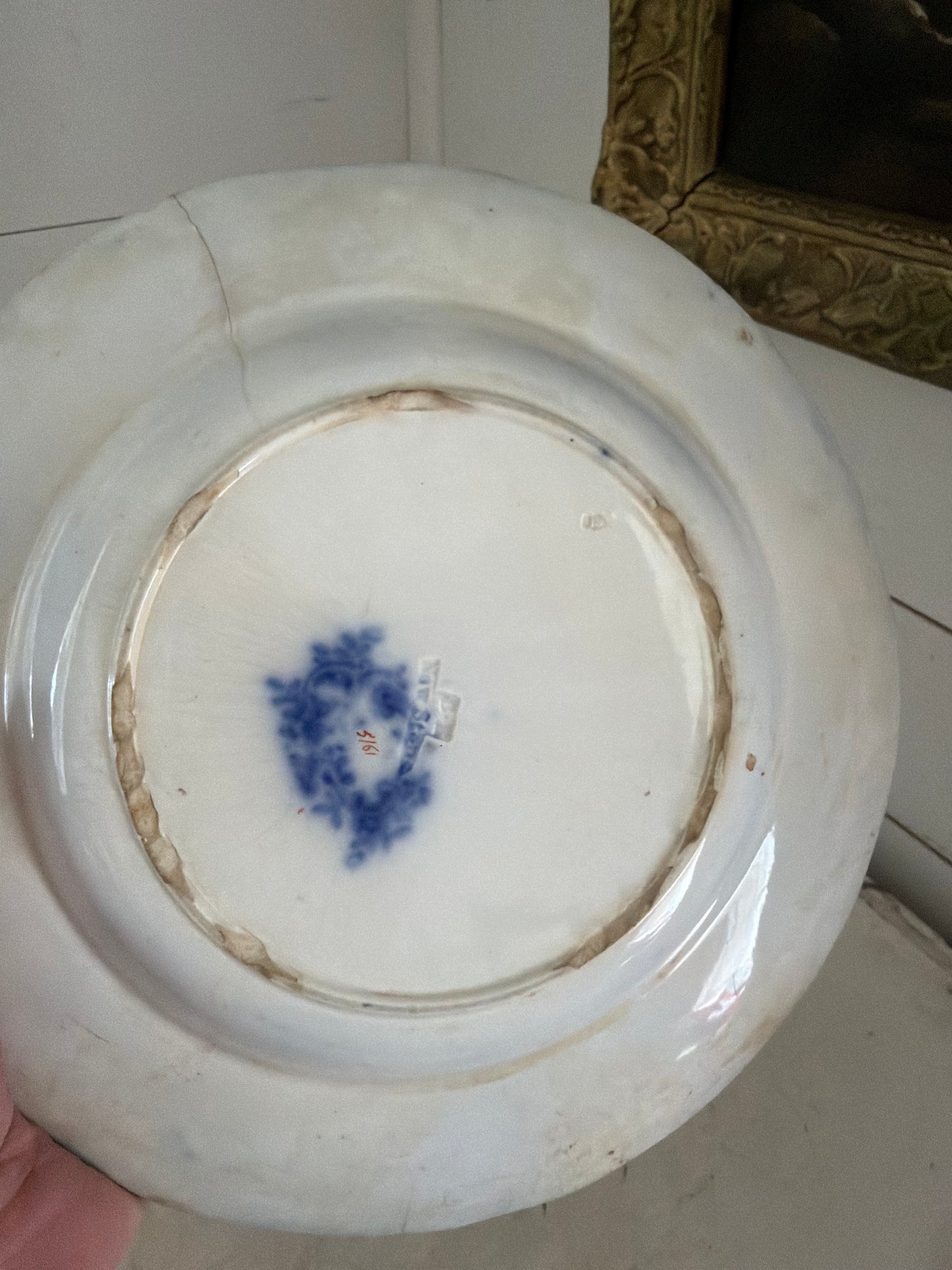 Flow blue plate made in England has small crack