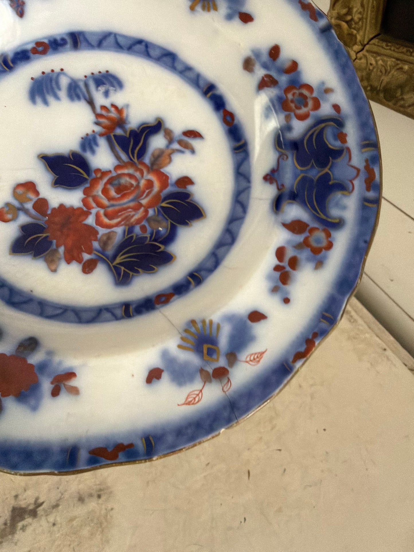 Flow blue plate made in England has small crack